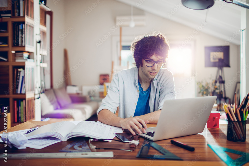Young caucasian man using a laptop at studying at home Young caucasian man using a laptop at studying at home