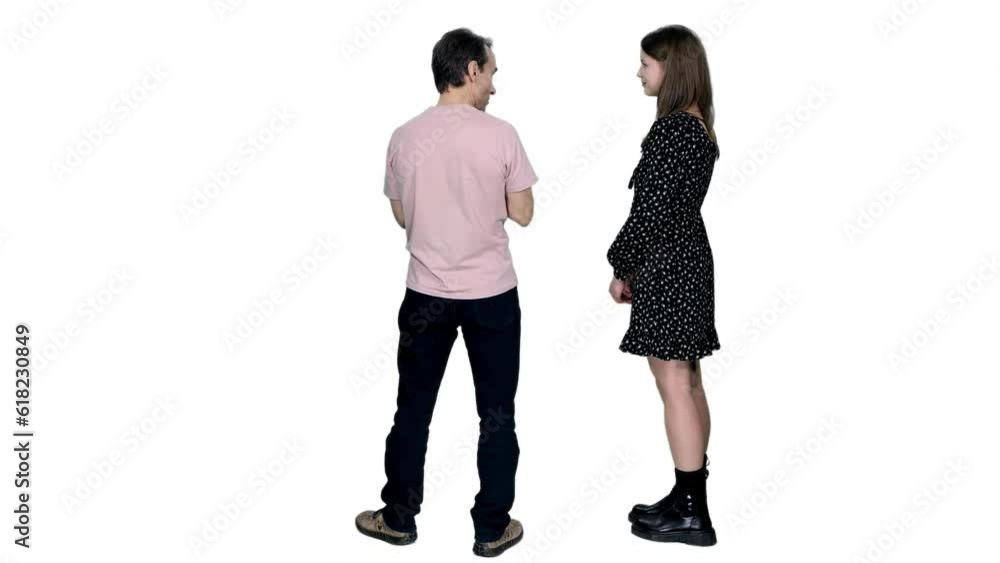 Back view adult man in casual wear explaining something to girl in black polka-dot dress, Full HD footage with alpha transparency channel isolated on white background Back view adult man in casual wear explaining something to girl in black polka-dot dress, Full HD footage with alpha transparency channel isolated on white background