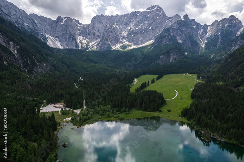 Fusine Lake in Italy with Alps mountains in background , Europe. Aerial drone view.