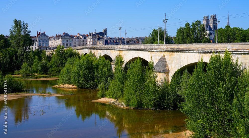 George V bridge crossing the Loire river in Orléans in the Loiret department in Centre-Val de Loire, France - Arched masonry bridge built in the 17th century used by the road and the tramway