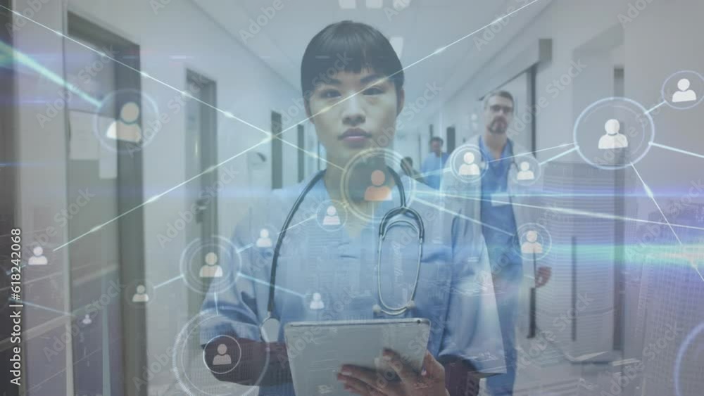Animation of network of connections over asian female doctor in hospital Animation of network of connections over asian female doctor in hospital