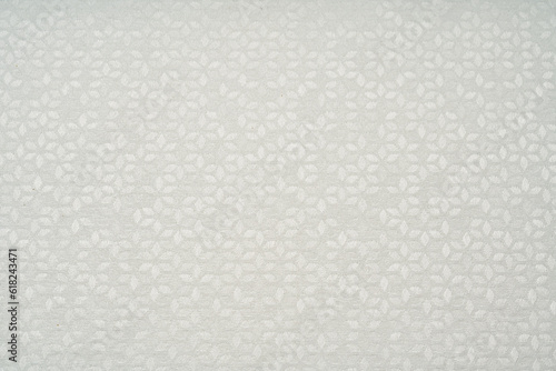 White fabric texture with an abstract pattern.