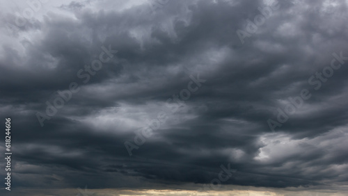 The dark sky with heavy clouds converging and a violent storm before the rain.Bad or moody weather sky and environment. carbon dioxide emissions  greenhouse effect  global warming  climate change