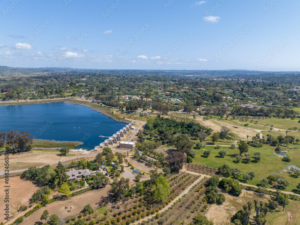 Aerial view over water reservoir and a large dam that holds water. Rancho Santa Fe in San Diego, California, USA