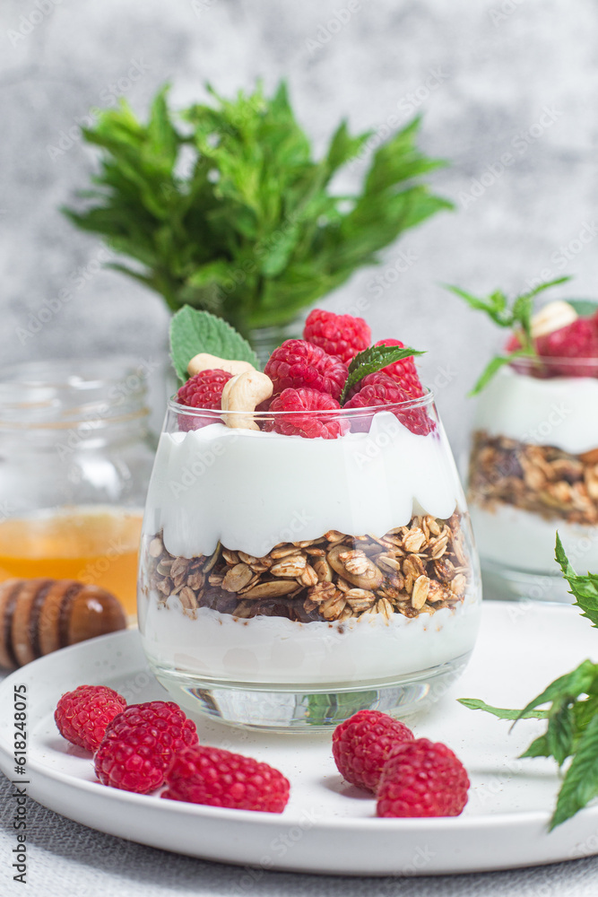Granola with yogurt and raspberries in a glass Granola with yogurt and raspberries in a glass