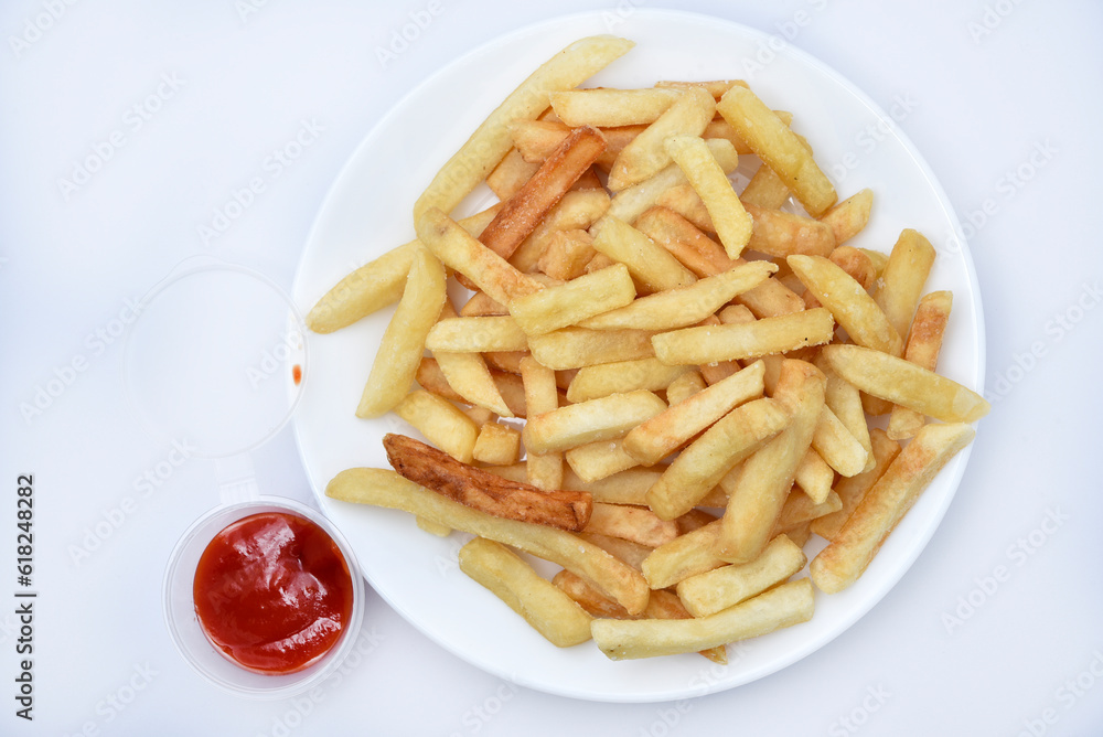 French fries on a white plate and sauce. Delicious breakfast of fried potatoes.