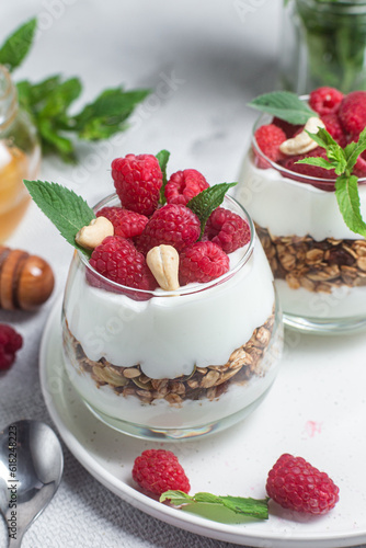 Granola with yogurt and raspberries in a glass