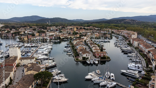 Port Grimaud harbor in France in springtime with yachts and sailboats and Mediterranean Sea by day, drone shot, Cote d'Azur © A.Freund