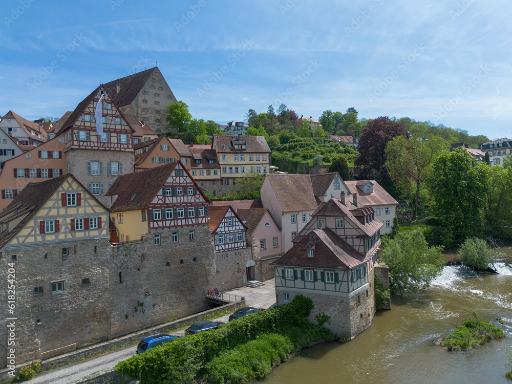 Schwaebisch Hall, old town houses with a view of the Kocher River and a small barrage recorded with a drone