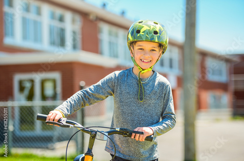 child having fun outdoors driving bike for children on playground