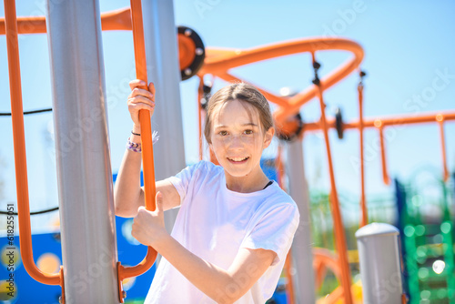 teenager girl on a playground on summer day.