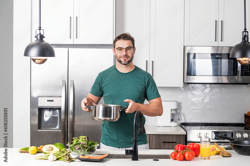 Man chef cooking food in pan pot in kitchen. Process of preparing gourmet dish. Man cooking at home in kitchen, using pot. Chef cooking food. Handsome chef cook cooking concept. Man chef cooking food in pan pot in kitchen. Process of preparing gourmet dish. Man cooking at home in kitchen, using pot. Chef cooking food. Handsome chef cook cooking concept.