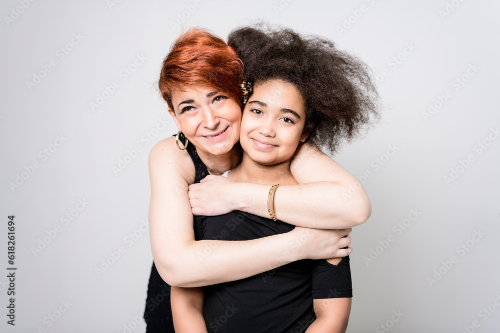 Portrait of a mature woman on studio background with her child Portrait of a mature woman on studio background with her child