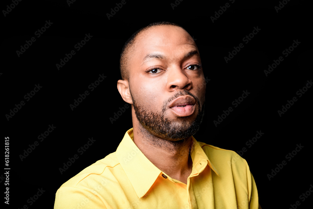 black African Man with yellow clothes on studio black background black African Man with yellow clothes on studio black background