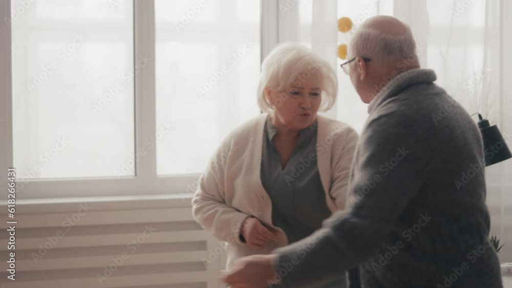 Joyful senior couple dancing and having fun at home, happy marriage, leisure Joyful senior couple dancing and having fun at home, happy marriage, leisure