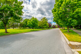 A tree lined street in a suburban housing community with parks and greenspace in Coeur d'Alene, Idaho, USA.