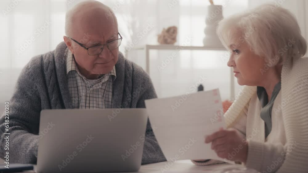 Upset senior couple calculating family budget, having financial problems, debt Upset senior couple calculating family budget, having financial problems, debt