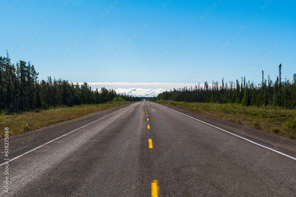 Open road through forest, NT, Canada Open road through forest, NT, Canada