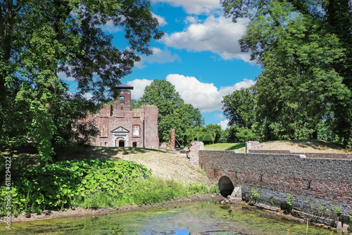 Beautiful medieval brick stone castle ruin, bridge over water moat - Kasteel Bleijenbeek, Afferden, Netherlands photo