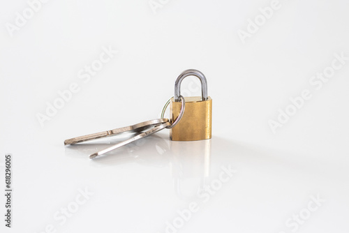 Gold locked padlock and keys on white background. Home security concept