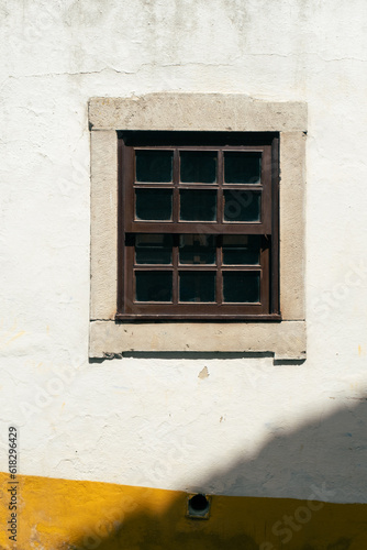 Brown wooden window frame in a wall