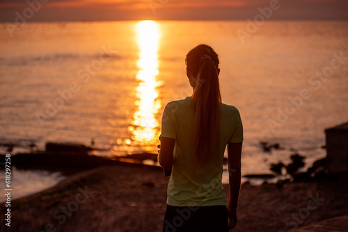 Portrait of young woman in sportswear, stopped for break between workouts. Sportswoman looks at dawn © farmuty