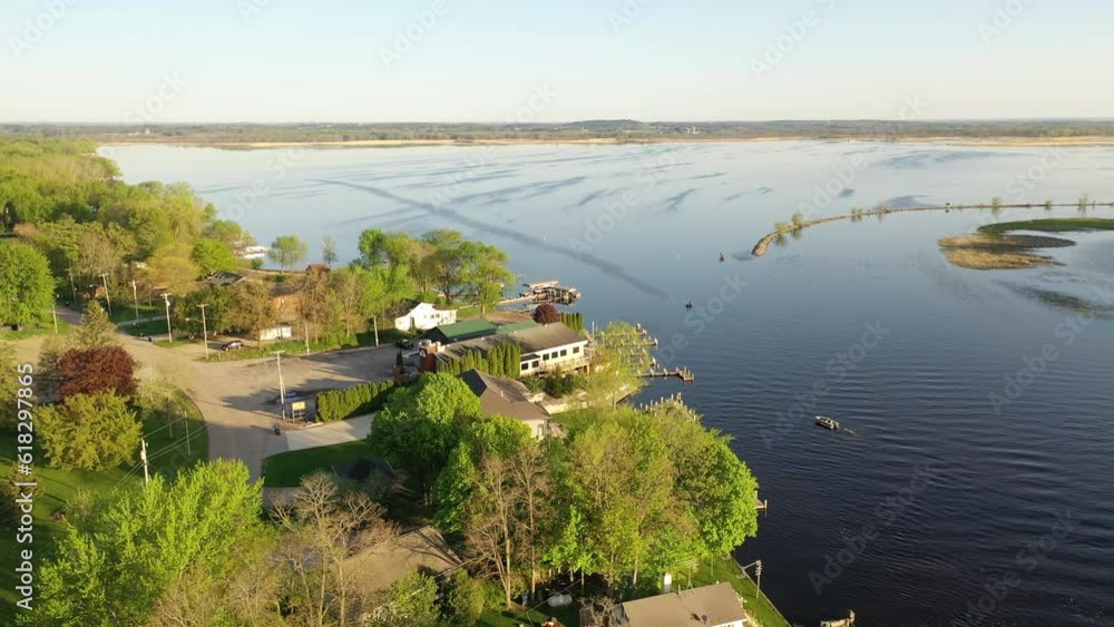 Aerial view of Fremont, Wisconsin: houses, river, boats. Serene, picturesque town blending nature, suburban charm, and riverside living. Explore the beauty from above Aerial view of Fremont, Wisconsin: houses, river, boats. Serene, picturesque town blending nature, suburban charm, and riverside living. Explore the beauty from above