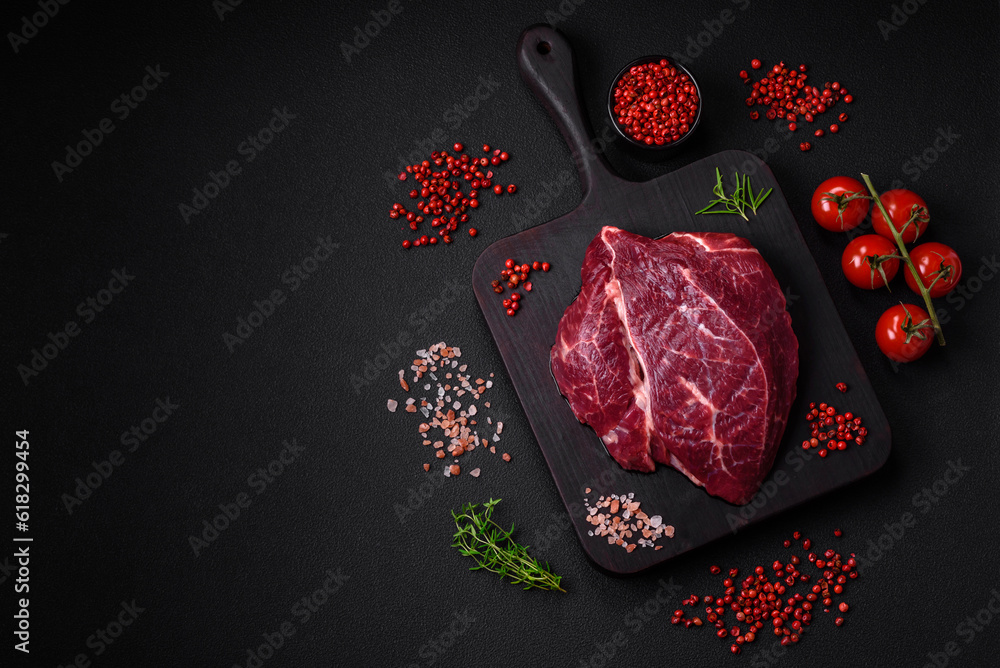 Fototapeta premium Fresh raw beef steak with salt, spices and herbs