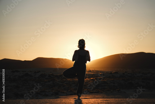 Caucassian woman doing yoga on sunset
