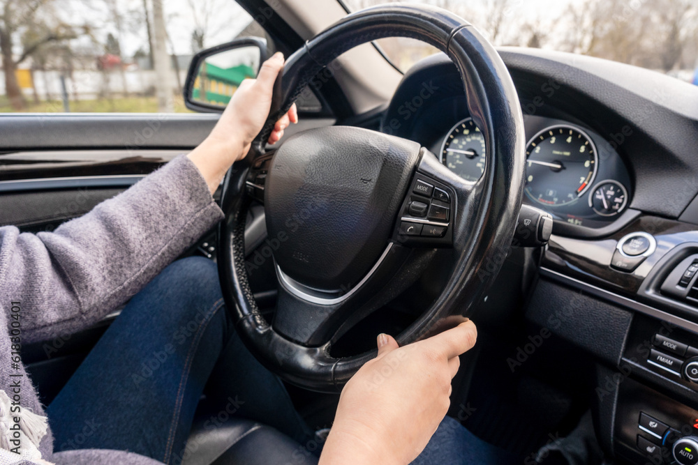 Women's hands holding steering wheel of the car. Driving Women's hands holding steering wheel of the car. Driving