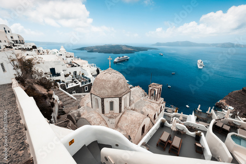 magical and sun covered city of thira, ideal for vacation and travel during hot summer days, on the horizon the sea and beautiful roofs of houses, travel and relaxation in greece,white and blue 