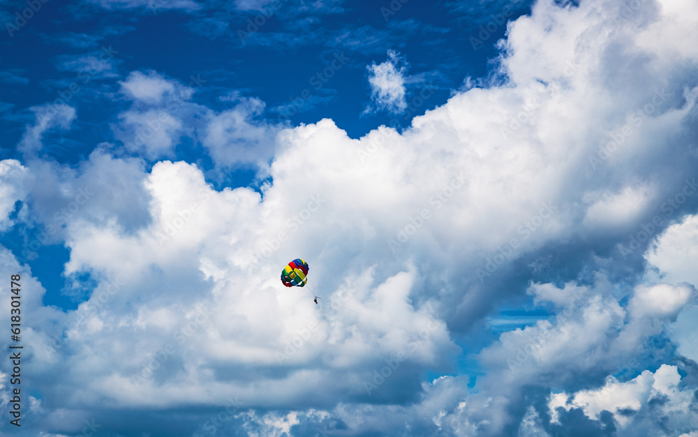parasailing against blue sky rainbow colors parasailing against blue sky rainbow colors