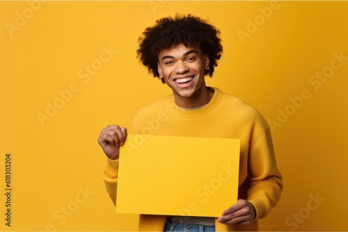 Cheerful black man with blank paper