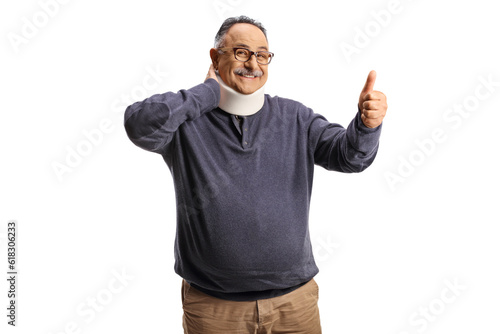 Mature man with a cervical collar holding his neck and gesturing thumbs up