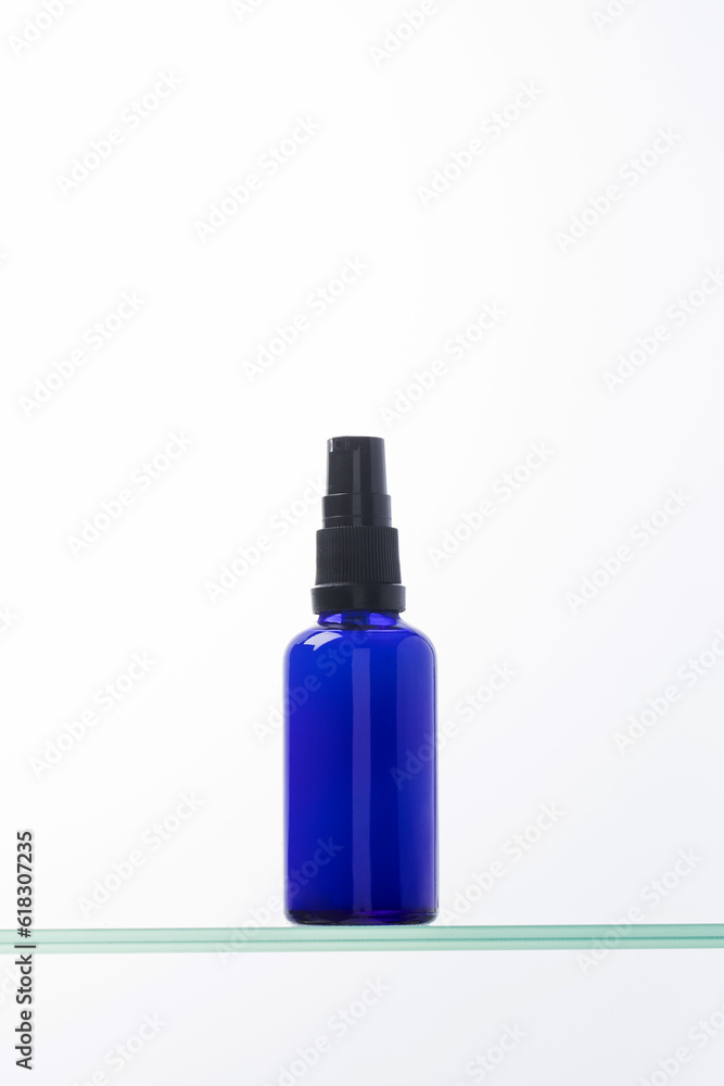 Serum for facial skin in a dropper on a glass shelf. Anti-aging cosmetics.