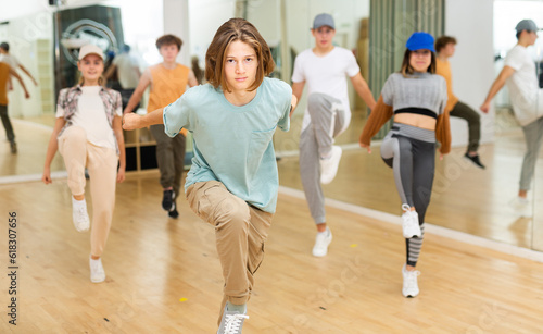 Young boys and girls performing contemporary dance in studio.