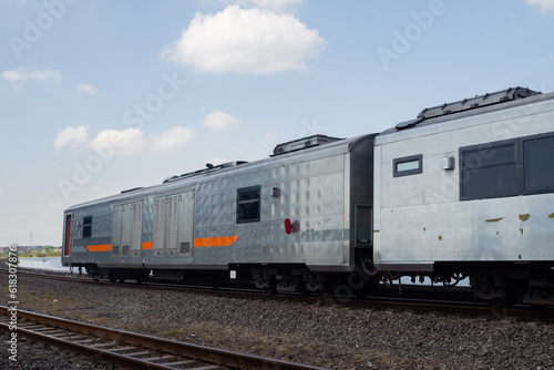 Domestic train pass the rail way when day time with blue sky.