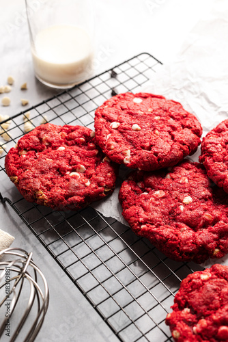 Red velvet cookies on a cookie rack with ingredients