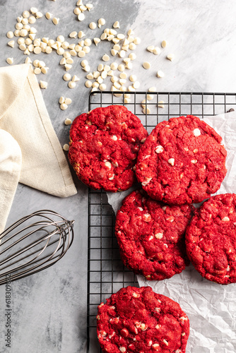Red velvet cookies on a cookie rack with ingredients