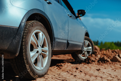 Car standing offroad on mud and sand
