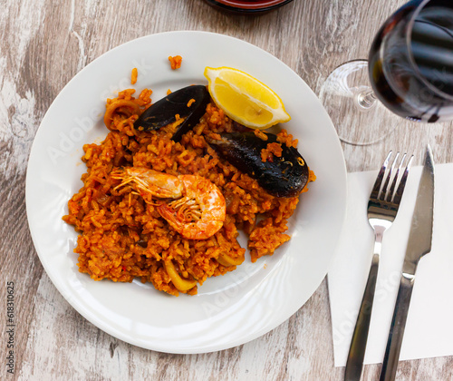 Delicious traditional Valencian seafood paella - savory rice dish with shrimps and clams. High quality photo photo