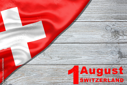 Swiss National Day greeting card. Date August 1 and text in English on a wooden table: 1. August Switzerland. Vector banner with the flag of Switzerland.