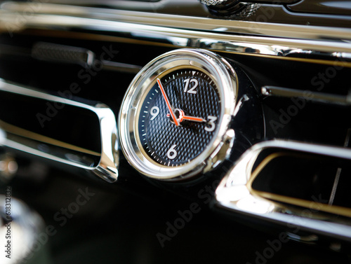 expensive first-class mechanical clock in the dashboard of a yacht or an expensive car