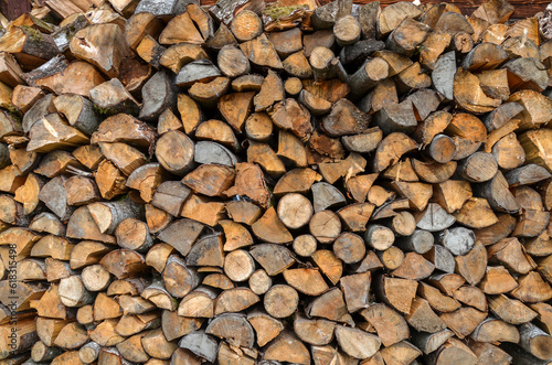Dry сhopped and stacked firewood close up for home heating consumption in the countryside. Natural texture or background