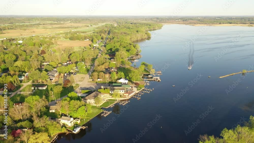 Aerial view of Fremont, Wisconsin: houses, river, boats. Serene, picturesque town blending nature, suburban charm, and riverside living. Explore the beauty from above Aerial view of Fremont, Wisconsin: houses, river, boats. Serene, picturesque town blending nature, suburban charm, and riverside living. Explore the beauty from above
