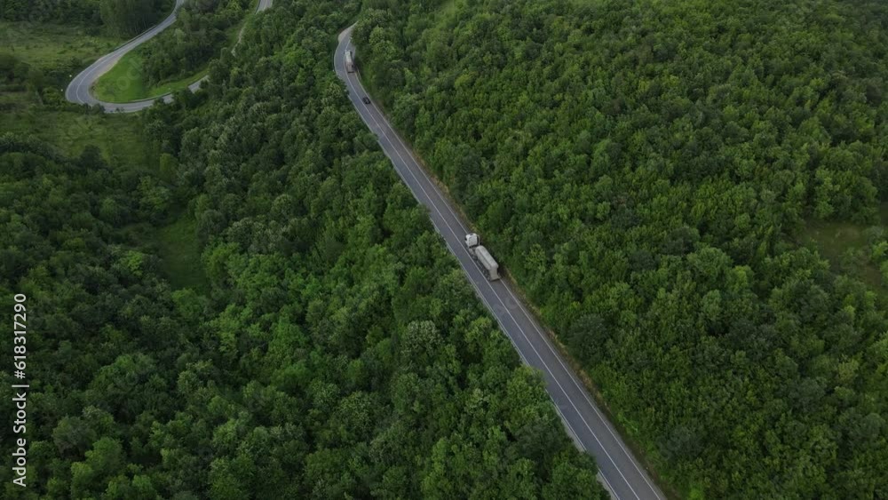 Aerial Drone View truck Drive on Curvy Mountain asphalt Road in Spring Aerial Drone View truck Drive on Curvy Mountain asphalt Road in Spring