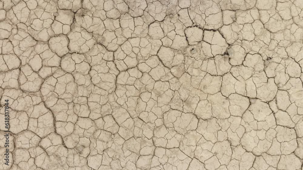 Aerial shot looking down at the cracked surface of a dry lake. Aerial shot looking down at the cracked surface of a dry lake.