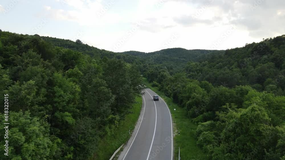 Aerial Drone View Car Driving on Curvy Mountain asphalt Road in summer Aerial Drone View Car Driving on Curvy Mountain asphalt Road in summer