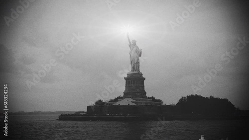 Old film style nostalgic statue of liberty with glowing torch