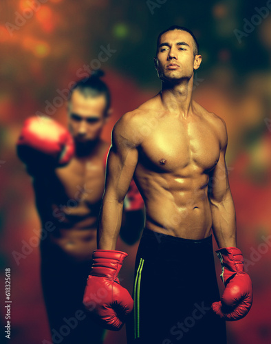 Young muscular boxer in gym